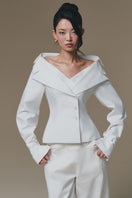 White Selena shirt by Keira Tong, stylish button-up shirt with collar and long sleeves, displayed on a hanger.