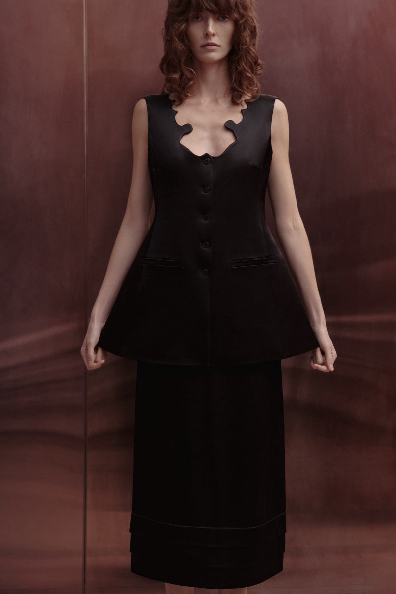 Black Shalivka midi skirt by Podyh, featuring a flowing fabric and elegant midi length, shown on a model.