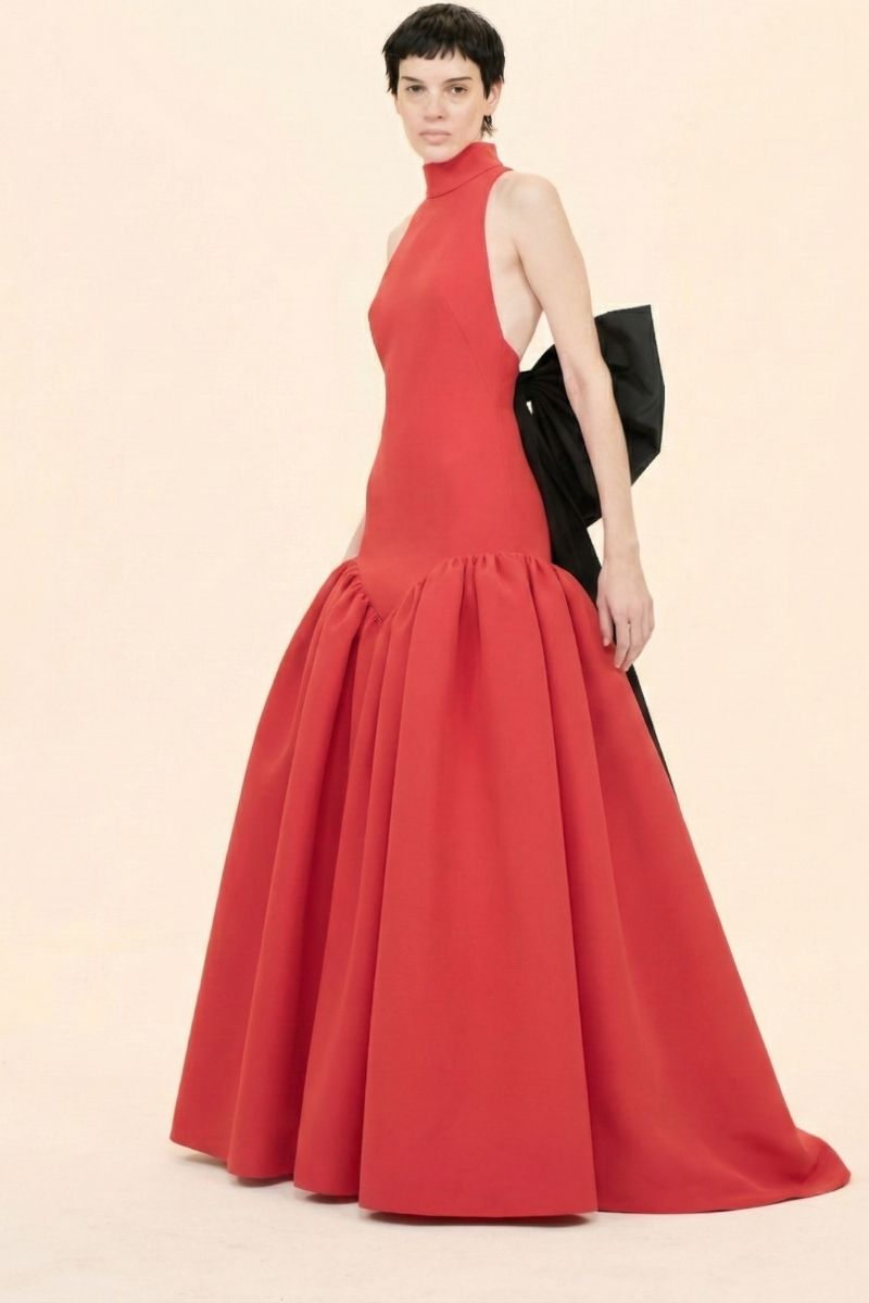 Nihan Peker ÉVAN red gown with elegant flowing fabric and intricate detailing, showcased on a mannequin.