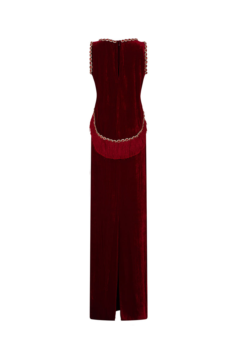 Red Valenciani gown with shoulder cutouts, elegant cape design, long flowing fabric, perfect for formal occasions.