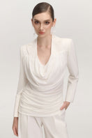 White JEMMIA pants by Arti Apparel, featuring a relaxed fit and stylish design, displayed on a model.