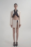 Black sequined underwear styled with a beige mini skirt from Blikvanger, showcasing a chic, sparkling fashion look.