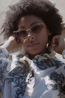 Brown Forget Me Not sunglasses by Moy Atelier with round frames and tinted lenses, shown on a neutral background.