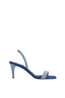A pair of Claudia blue denim slingback sandals by AERA with open toes and ankle straps, placed on a neutral background.
