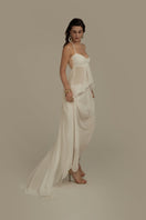 Poem Halcyon white maxi dress displayed on a hanger, flowing fabric, elegant design perfect for summer or casual occasions.