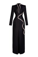 Black sheath gown with a wave neckline by GVLUX, featuring sleek fabric and elegant design, perfect for formal occasions.