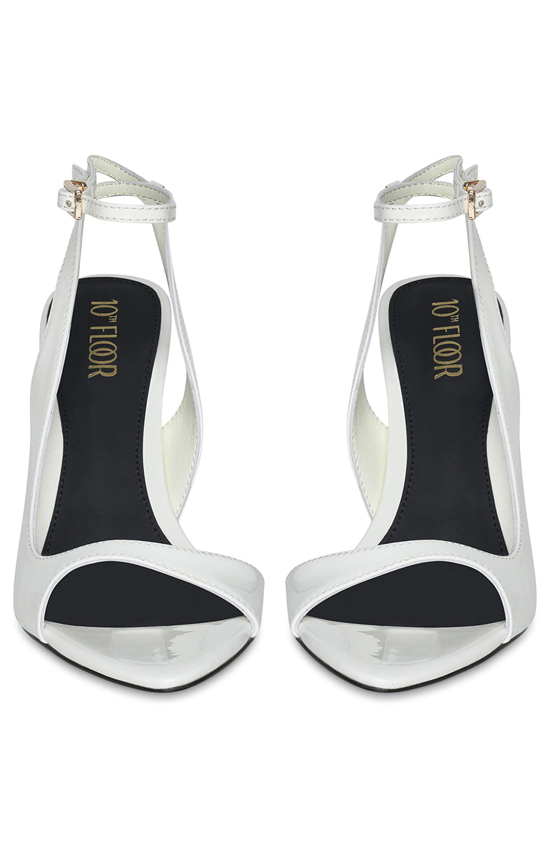 White MIDNIGHTS heels by 10TH FLOOR, stylish high-heeled shoes with sleek design and elegant ankle straps.