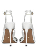 White high heels from 10th Floor's Midnights Heel collection, featuring elegant pointed toes and sleek heel design.