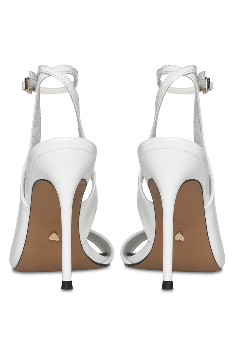 White high heels from 10th Floor's Midnights Heel collection, featuring elegant pointed toes and sleek heel design.