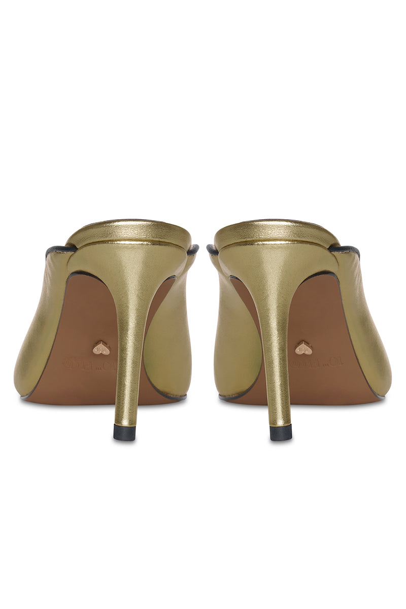 Gold RIVA heels by 10TH FLOOR featuring a sleek design with a pointed toe and stiletto heel.