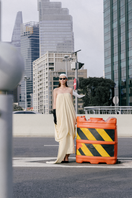Elegant Butter Muse gown by TONYY featuring flowing fabric and intricate detailing, perfect for formal occasions.