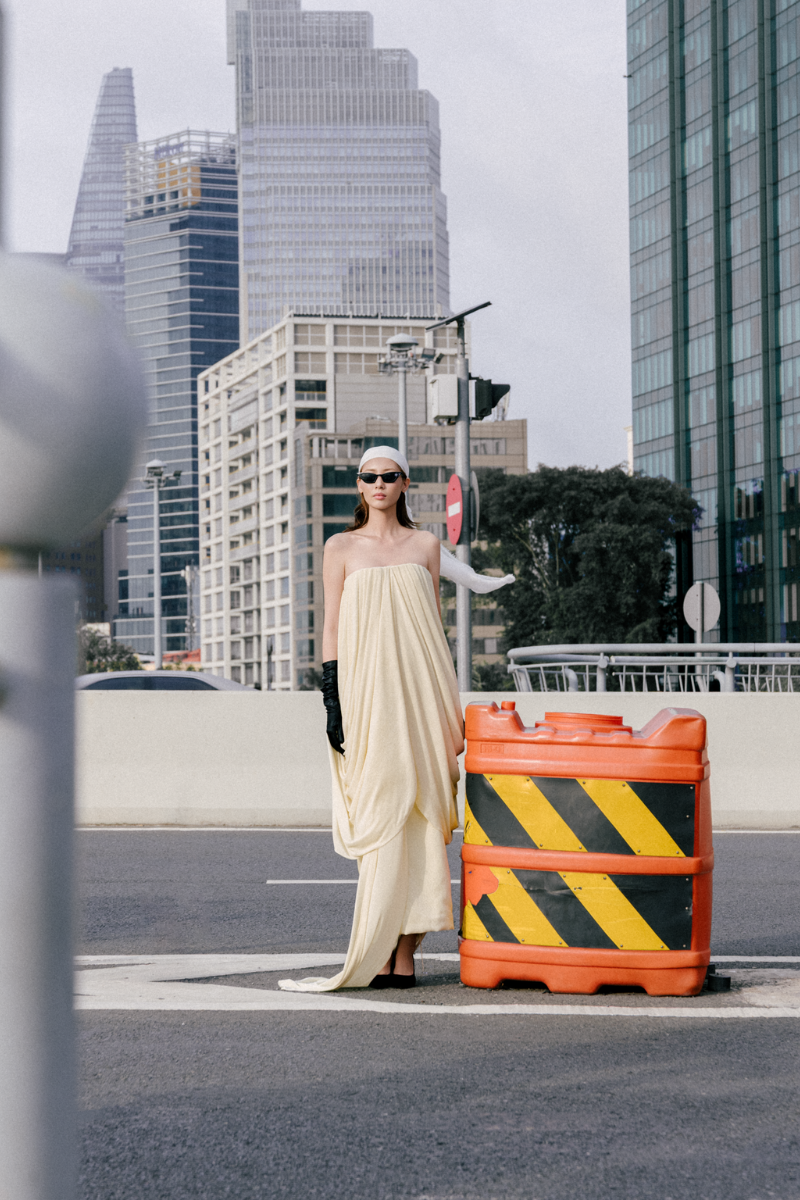 Elegant Butter Muse gown by TONYY featuring flowing fabric and intricate detailing, perfect for formal occasions.
