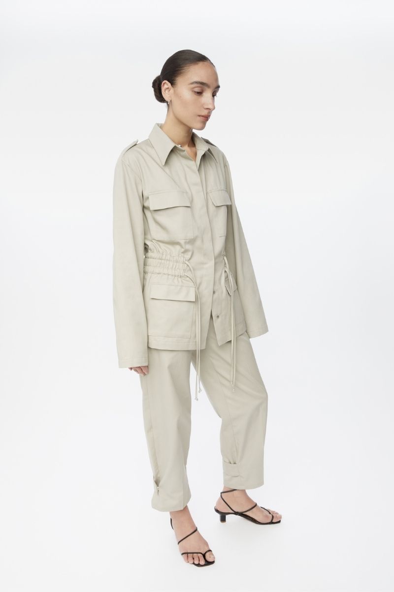 Dāl the Label canvas cotton jacket with front pockets and button closure, displayed on a hanger.