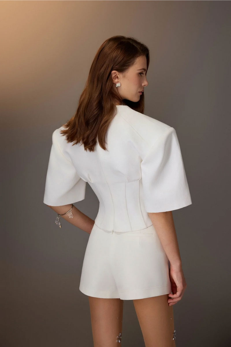White minimal skort by KEIRA TONG, styled as a chic mini dress with clean lines and simple design.