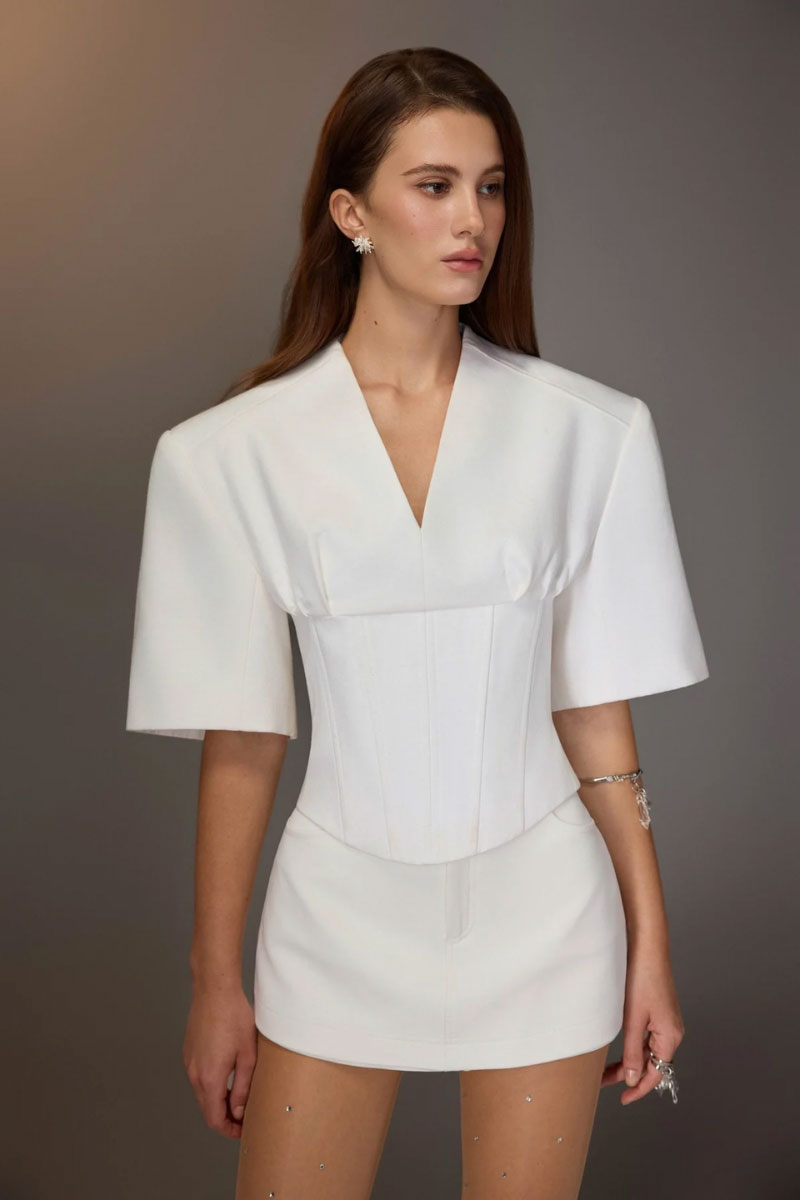 White minimal skort by KEIRA TONG, showcasing a sleek, modern mini skirt with clean lines and a minimalist design.