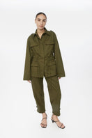 Dāl the Label canvas cotton jacket displayed on a hanger, showing its relaxed fit and natural beige color.