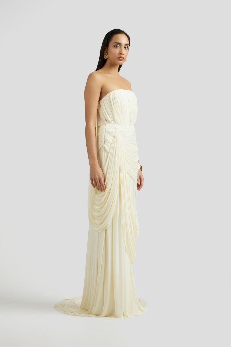 Deme By Gabriella Naomi maxi dress in off-white with flowing fabric and elegant design, perfect for summer or special occasions.