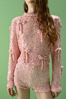 Lalo Salue long sleeve sweater in pink, soft knit fabric, shown on a model, featuring a relaxed fit and ribbed cuffs.