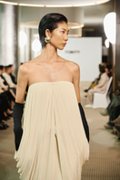 Elegant Butter Muse gown by TONYY featuring flowing fabric and intricate detailing, perfect for formal occasions.