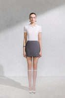 Arti Apparel Elyss mini skirt in black, stylish high-waisted design with a fitted silhouette, shown on a hanger.