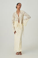 Summer Away Merlette shirt in pale yellow, soft fabric, with a relaxed fit and button-front design, displayed on a hanger.
