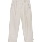 Dāl the Label canvas cotton pants showing relaxed fit and beige color, with visible pockets and stitching details.