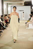 Elegant Butter Muse gown by TONYY featuring soft pastel fabric and flowing silhouette, perfect for formal occasions.
