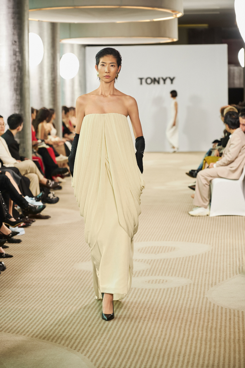 Elegant Butter Muse gown by TONYY featuring soft pastel fabric and flowing silhouette, perfect for formal occasions.