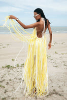 Yellow Valenciani halter neck fringed maxi dress displayed on a mannequin, showcasing its flowing design and vibrant color.