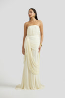 Deme By Gabriella Naomi maxi dress in off-white with flowing fabric and sleeveless design, displayed on a mannequin.