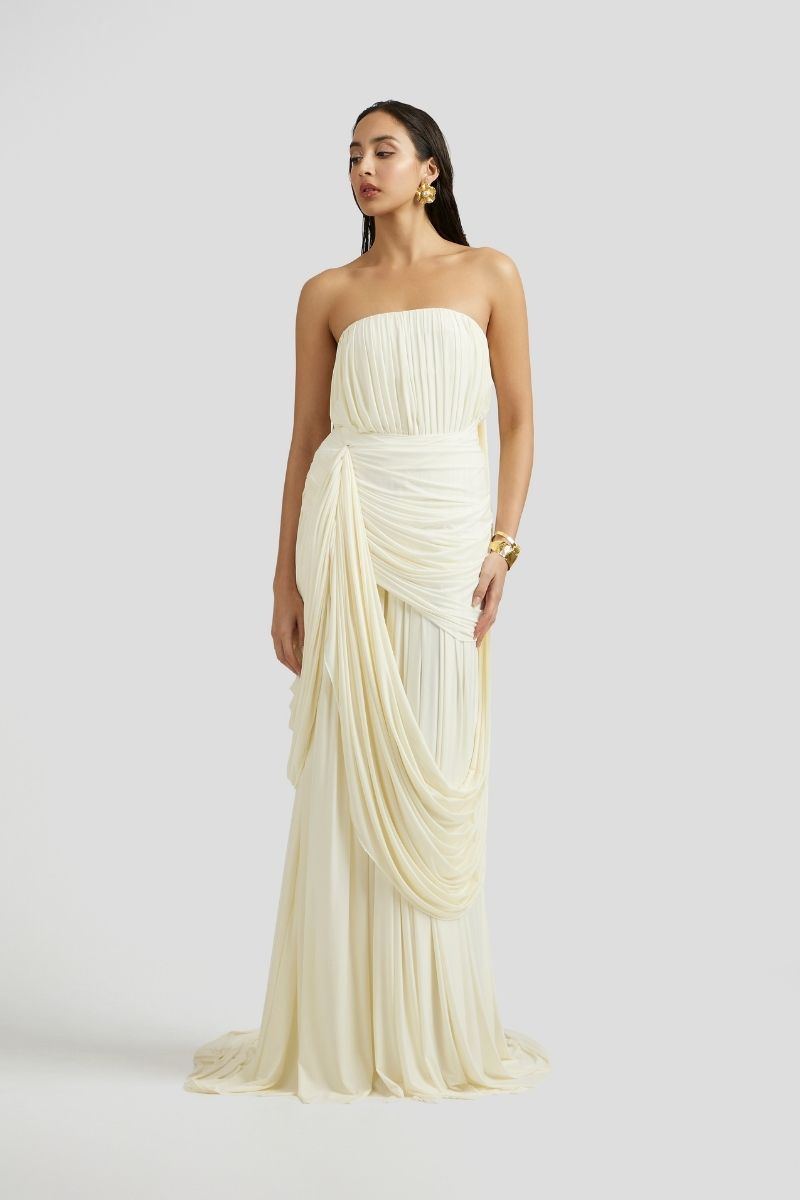 Deme By Gabriella Naomi maxi dress in off-white with flowing fabric and sleeveless design, displayed on a mannequin.