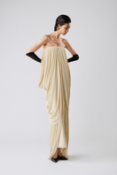 Elegant butter-colored gown by TONYY, featuring flowing fabric and intricate design, perfect for formal occasions.