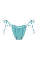 Bright turquoise Suncillo Virna sparkly bikini bottom with shimmering details, styled for beach or poolside wear.