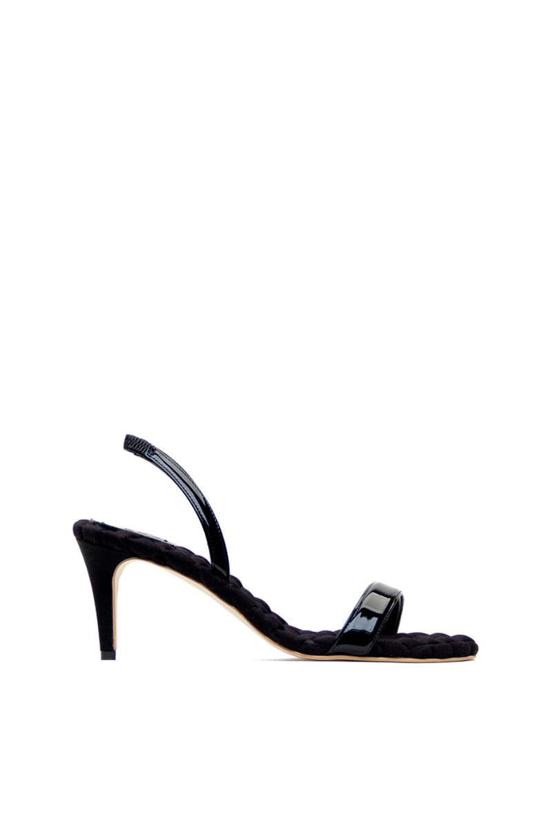 A pair of black patent-effect slingback sandals by AERA with a sleek, glossy finish and open-toe design.