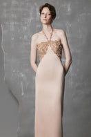 Gold long bodycon gown with sculpted bust by Phan Huy, featuring a fitted silhouette and elegant design.