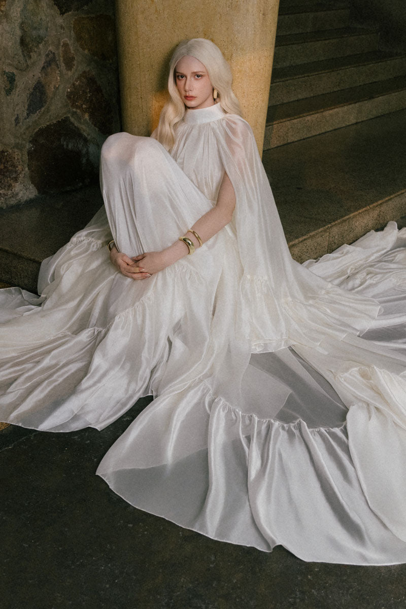 White Plan Antonia Maxi Dress shown on a hanger with flowing fabric and simple elegant design.