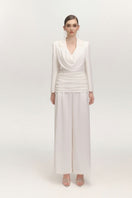 White JEMMIA pants by Arti Apparel, showcasing the relaxed fit and soft fabric, styled with a casual look.