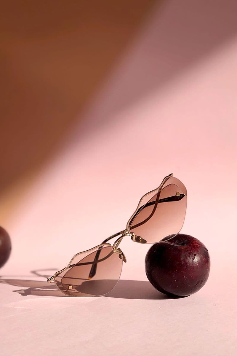 Brown Forget Me Not sunglasses by Moy Atelier with rounded frames and dark tinted lenses, stylish and fashionable eyewear.
