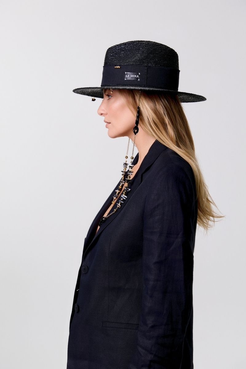 Black fedora hat by LE SH KA featuring shell embellishments and 24K gold-plated accessories, stylish and unique headwear.