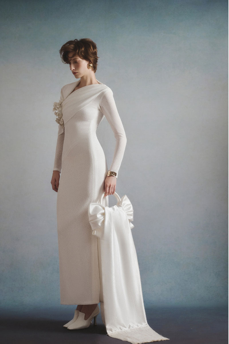 White Plan Celeste draped maxi dress with flowing fabric and elegant design, shown on a model.