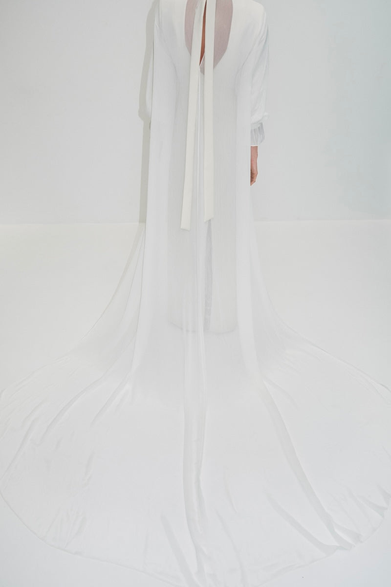 Elegant bridal cape in bambula silk featuring delicate detailing, designed for wedding cover-ups by JC Pajares.