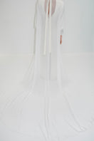 Elegant bridal cape in bambula silk by JC Pajares, featuring delicate draping and luxurious fabric for wedding cover-up.