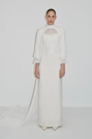 Elegant bridal cape in Bambula silk by JC Pajares, featuring flowing fabric and intricate details for a sophisticated wedding look.