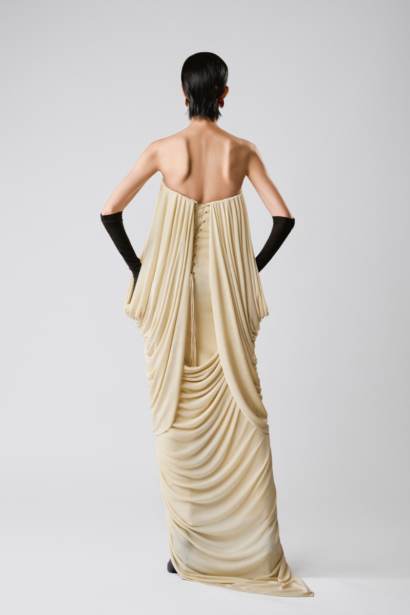 Elegant Butter Muse gown by TONYY featuring flowing fabric and intricate detailing for formal occasions.