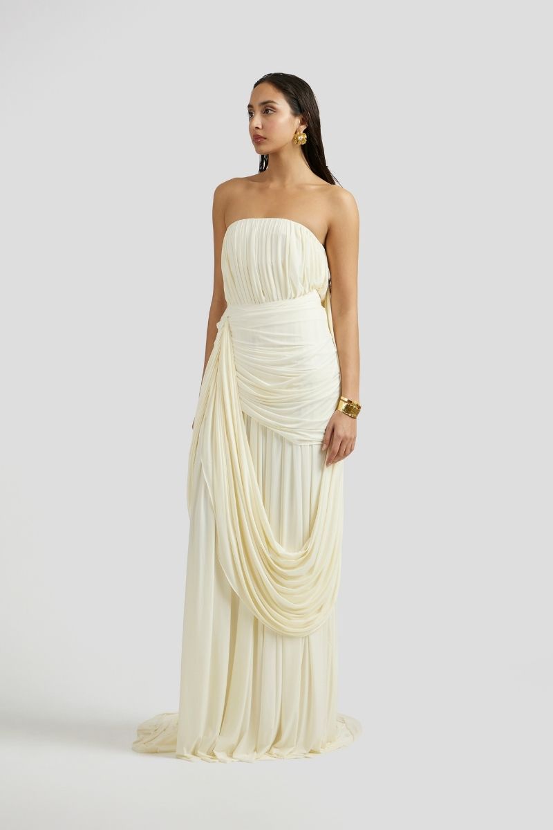 Deme By Gabriella Naomi maxi dress in off-white with flowing fabric and elegant design, perfect for summer or special occasions.