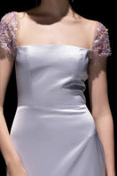 21Six Veri Peri Cara Silk Satin Gown with attached flowing skirt and elegant neckline, showcased on a mannequin.