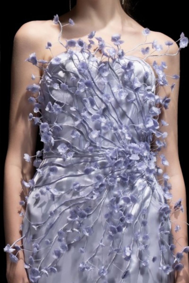 Elegant Veri Peri Connie silk satin gown with floral details from 21Six, shown in a flowing design with intricate flower accents.