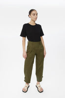 Light beige Dāl the Label canvas cotton pants displayed on a model, showcasing relaxed fit and casual style.