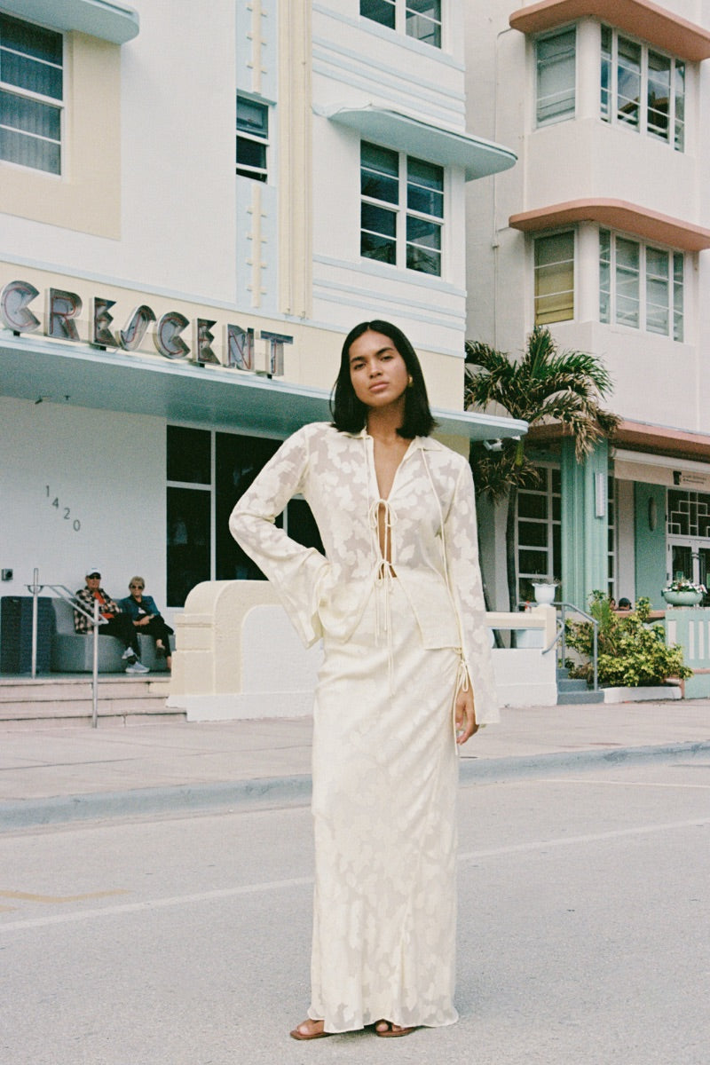 Summer Away Merlette shirt in pale yellow, lightweight tops with a relaxed fit and button-front design displayed on a hanger.