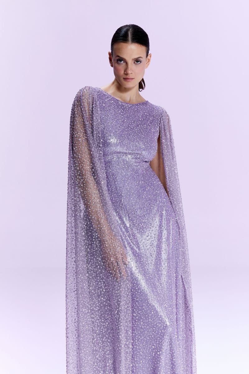Nur Karaata La Mamounia purple gown displayed on a hanger, featuring elegant fabric and intricate details.